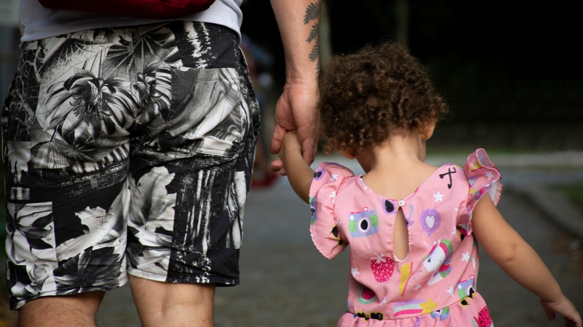 father and daughter holding hands